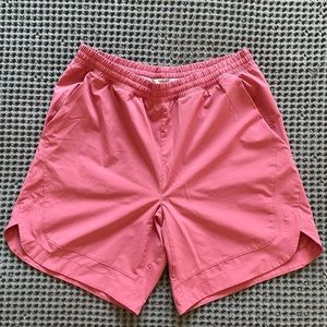 Men’s salmon colored shorts.